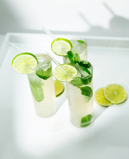 Three refreshing Mojito cocktails, garnished with mint aand lime.